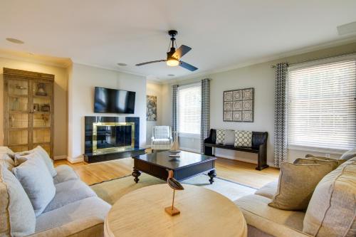 a living room with a couch and a table at Waterfront Cambridge Gem with Hot Tub, Pool and Dock! in Woolford
