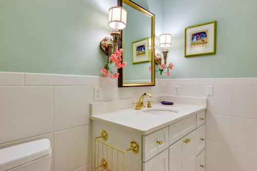 a bathroom with a sink and a mirror at Waterfront Cambridge Gem with Hot Tub, Pool and Dock! in Woolford