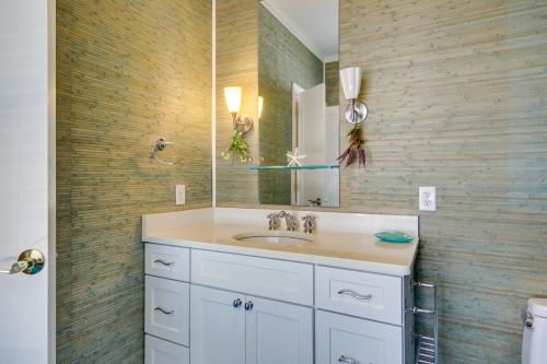 a bathroom with a sink and a mirror at Waterfront Cambridge Gem with Hot Tub, Pool and Dock! in Woolford