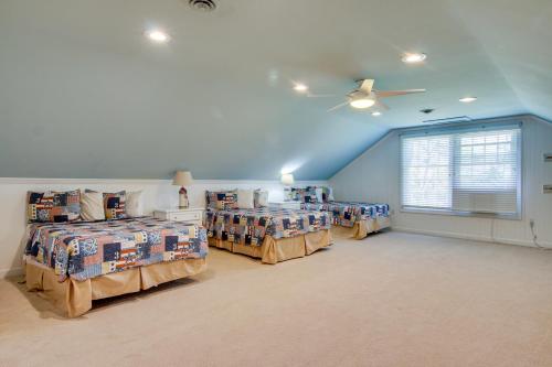 a bedroom with three beds and a ceiling fan at Waterfront Cambridge Gem with Hot Tub, Pool and Dock! in Woolford