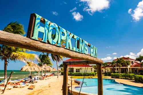 a sign for the beach at a resort at Hopkins Bay Belize a Muy'Ono Resort in Hopkins