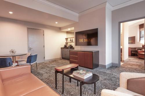 a living room with a couch and a table at The Dagny Boston in Boston