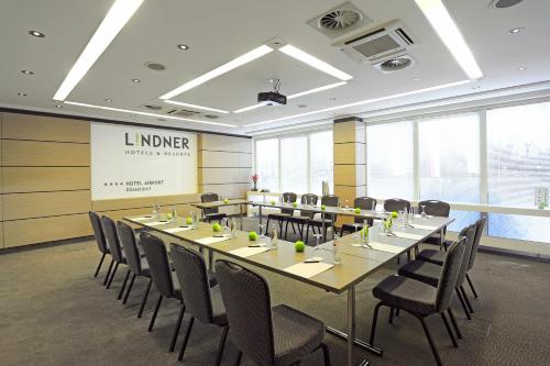 a conference room with a long table and chairs at Lindner Hotel Dusseldorf Airport, part of JdV by Hyatt in Düsseldorf
