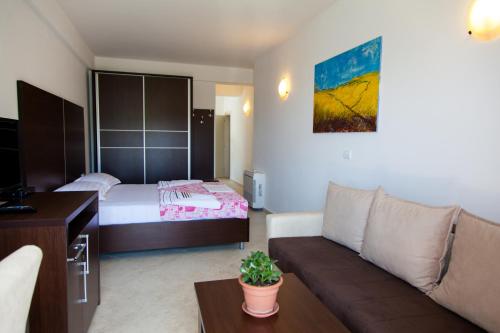 a living room with a couch and a bed at Apartments Art in Ulcinj