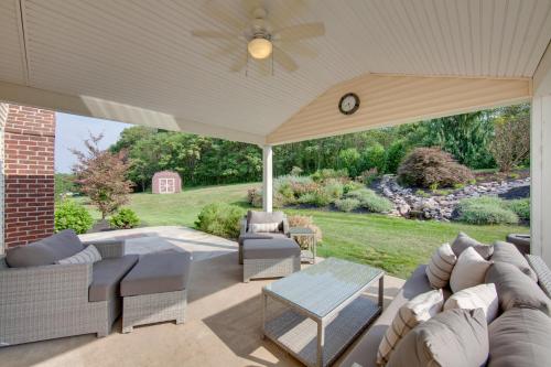a covered patio with a couch and a table at Game Room and Covered Patio Hummelstown Hideaway in Hummelstown