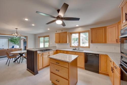 a kitchen with wooden cabinets and a ceiling fan at Game Room and Covered Patio Hummelstown Hideaway in Hummelstown