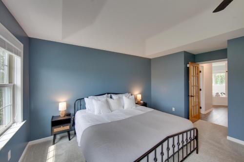 a bedroom with blue walls and a large bed at Game Room and Covered Patio Hummelstown Hideaway in Hummelstown