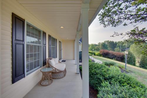 a porch of a house with a chair and a window at Game Room and Covered Patio Hummelstown Hideaway in Hummelstown