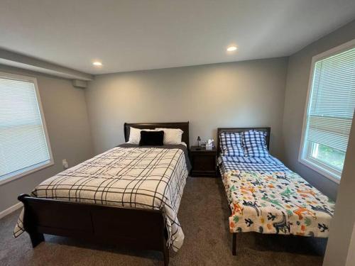 a bedroom with a bed next to a window at completely remodeled 4 bedrooms 2.5 baths in Baltimore