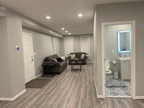 a living room with a couch and a chair at completely remodeled 4 bedrooms 2.5 baths in Baltimore