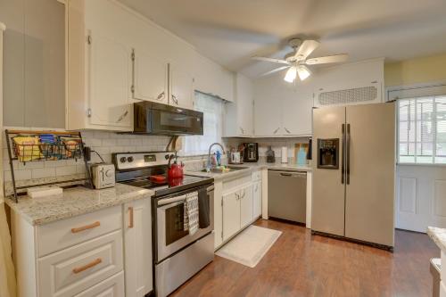 a kitchen with white appliances and a ceiling fan at Modern Birmingham Escape with Yard and Fire Pit! in Birmingham