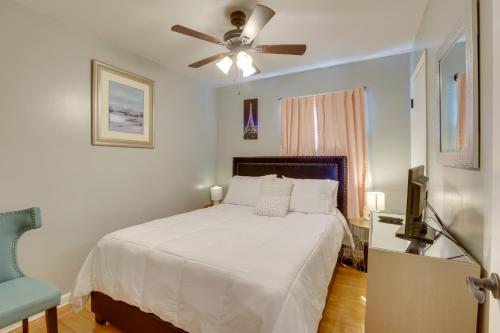 a bedroom with a white bed and a ceiling fan at Modern Birmingham Escape with Yard and Fire Pit! in Birmingham