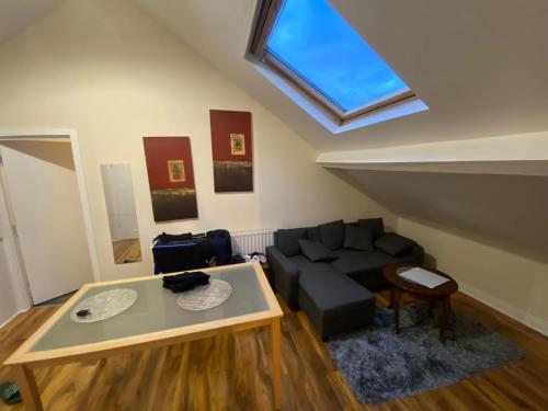 a living room with a couch and a window at Lovely room 5 minute walk from city centre in Newcastle upon Tyne