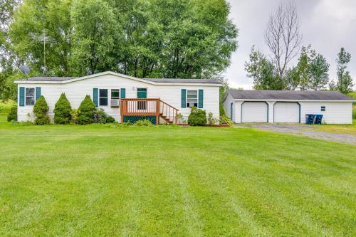 a white house with a large yard at Charming Watkins Glen Home with Deck and Yard! in Watkins Glen