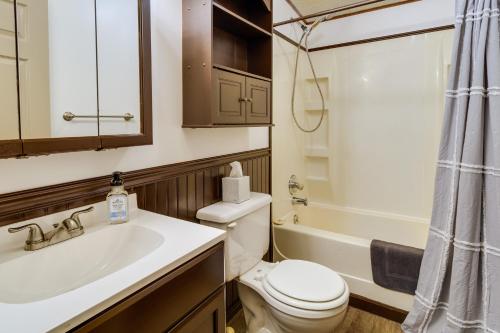a bathroom with a toilet and a sink and a tub at Charming Watkins Glen Home with Deck and Yard! in Watkins Glen