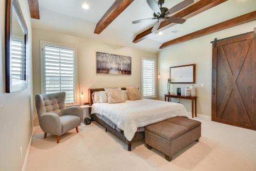 a bedroom with a bed and a chair and a ceiling fan at WFH-Friendly Amarillo Home with Furnished Patio! in Amarillo