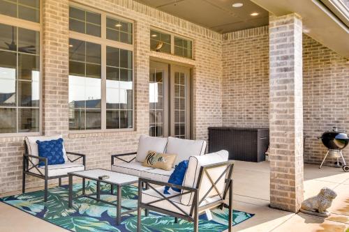 a patio with a couch and two chairs and a table at WFH-Friendly Amarillo Home with Furnished Patio! in Amarillo