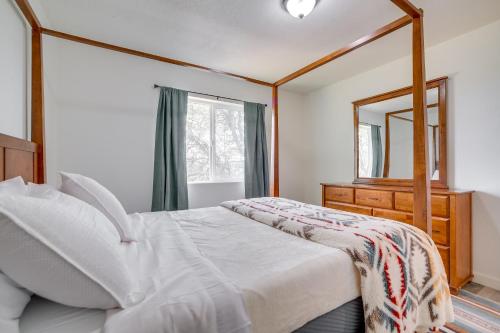 a bedroom with a bed with a mirror and a dresser at Tranquil Edgewood Retreat with Patio and Grill! in Edgewood