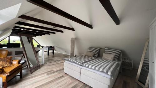 a living room with a bed and a table at Ferienhaus Villa Vogelsang (Schlei / Ostsee) in Stoltebüll