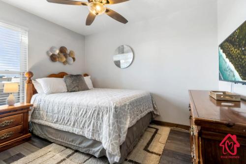 a bedroom with a bed and a ceiling fan at The Plaza - An Irvie Home w Summer Pool in Albuquerque