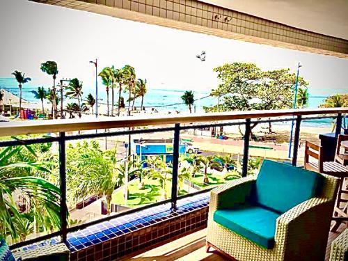 a balcony with a chair and a view of a beach at Landscape Beira Mar Deluxe Vista Mar in Fortaleza