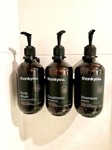 a group of three bottles of shampoo on a wall at Canopy by Hilton Washington DC Embassy Row in Washington