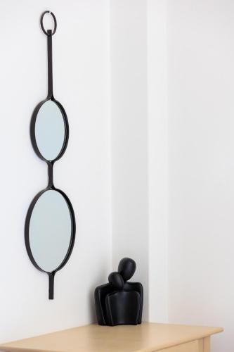two mirrors hanging on a wall next to a wooden shelf at Aerno Home & Azul Ηοme - Ahilli Slow Living in Kamari