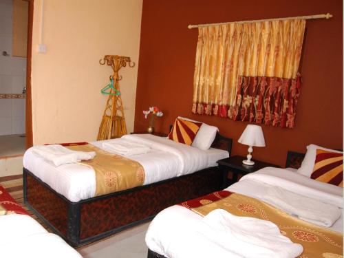 a hotel room with two beds and a tripod at Elbrus Home in Kathmandu