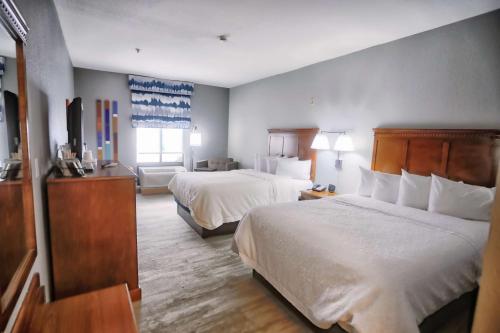 a hotel room with two beds and a television at Hampton Inn Marion in Marion