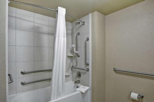 a bathroom with a shower with a white shower curtain at Hampton Inn Lewisburg in Lewisburg