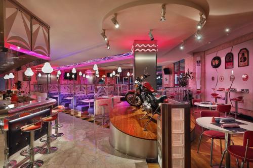 a restaurant with pink walls and a motorcycle on the counter at Jeddah Hilton in Jeddah
