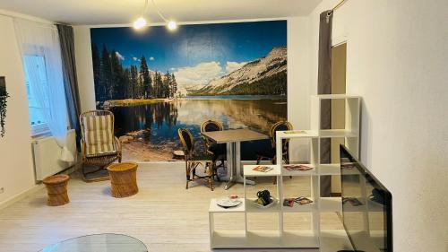 a room with a wall mural of a mountain lake at Wohnung im Zentrum von Albstadt in Albstadt