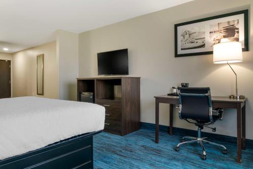 a hotel room with a bed and a desk and a chair at Best Western Clare Hotel in Clare