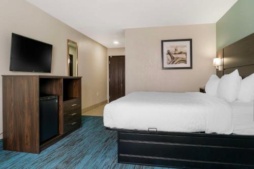 a hotel room with a bed and a flat screen tv at Best Western Clare Hotel in Clare