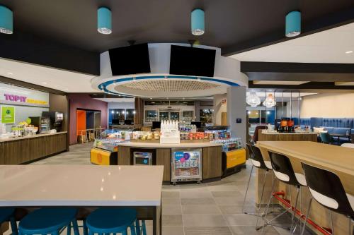 a fast food restaurant with tables and chairs at Tru By Hilton Traverse City in Traverse City