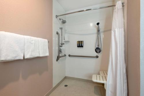 a bathroom with a shower with a white shower curtain at Best Western Plus Fort Worth North in Fort Worth