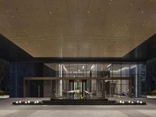 a large building with a statue in front of it at Hilton Zhuji in Zhuji