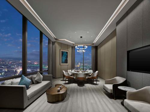 a living room with a couch and a table at Hilton Zhuji in Zhuji