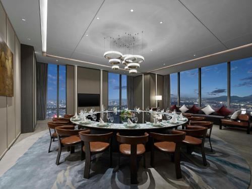 a dining room with a long table and chairs at Hilton Zhuji in Zhuji