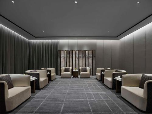 a waiting room with couches and chairs at Hilton Zhuji in Zhuji