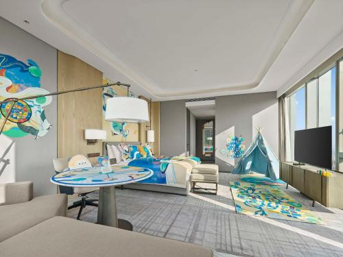 a childrens room with a bed and a table at Hilton Zhuji in Zhuji