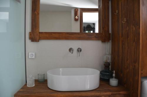 a bathroom with a white sink and a mirror at The Priest's Traditional House Kalithies in Kalithies