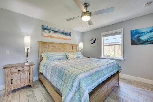 a bedroom with a bed and a ceiling fan at Modern Coastal Home with Pool Mins to Beach and Mayo! in Jacksonville Beach