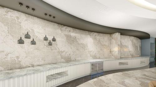 eine Darstellung einer Lobby mit einer Steinwand in der Unterkunft Hampton By Hilton Istanbul Airport, Arnavutkoy in Istanbul