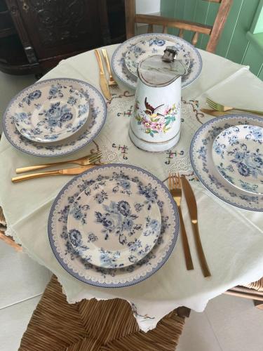 a table with blue and white plates on it at The Priest's Traditional House Kalithies in Kalithies