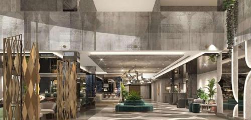 un vestíbulo de un edificio con mesas y plantas en DoubleTree by Hilton Yuksekova en Hakkari