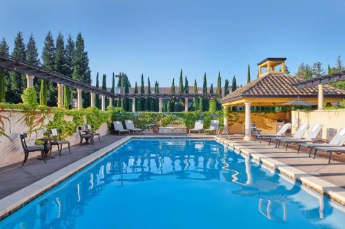 a swimming pool with chairs and a gazebo at The Lodge at Healdsburg, Tapestry Collection by Hilton in Healdsburg