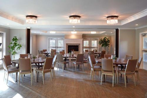 a dining room with tables and chairs and a fireplace at The Lodge at Healdsburg, Tapestry Collection by Hilton in Healdsburg