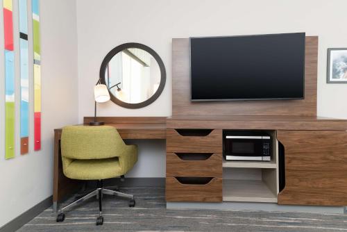 a room with a desk with a tv and a chair at Hampton Inn & Suites Santa Rosa Sonoma Wine Country in Santa Rosa