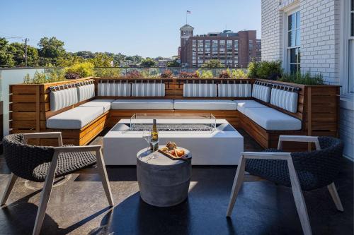 a rooftop patio with a table and two chairs at Wylie Hotel Atlanta, Tapestry Collection by Hilton in Atlanta